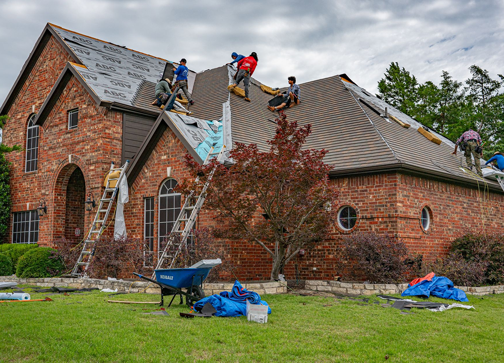 Roofing contractors working on a residential roof
